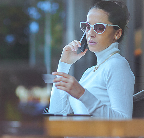 woman reviewing credit card purchases over the phone